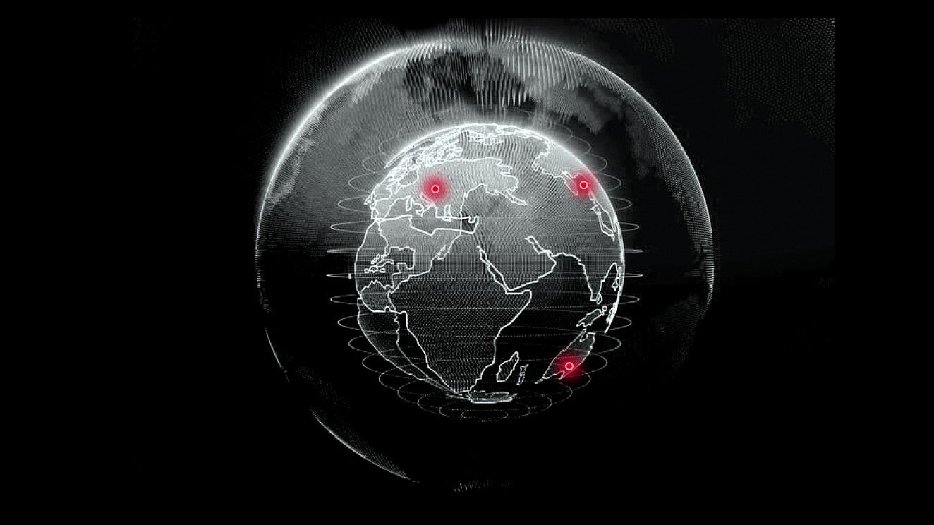 Ein schwarz-weißer Globus mit roten Markierungen in Europa, Asien und Australien