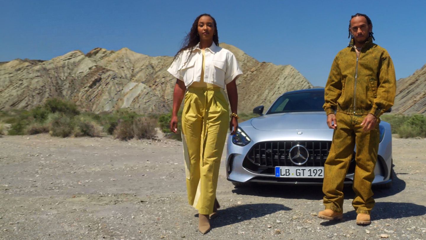 Naomi Schiff and Lewis Hamilton in front of the Mercedes-AMG GT Coupé
