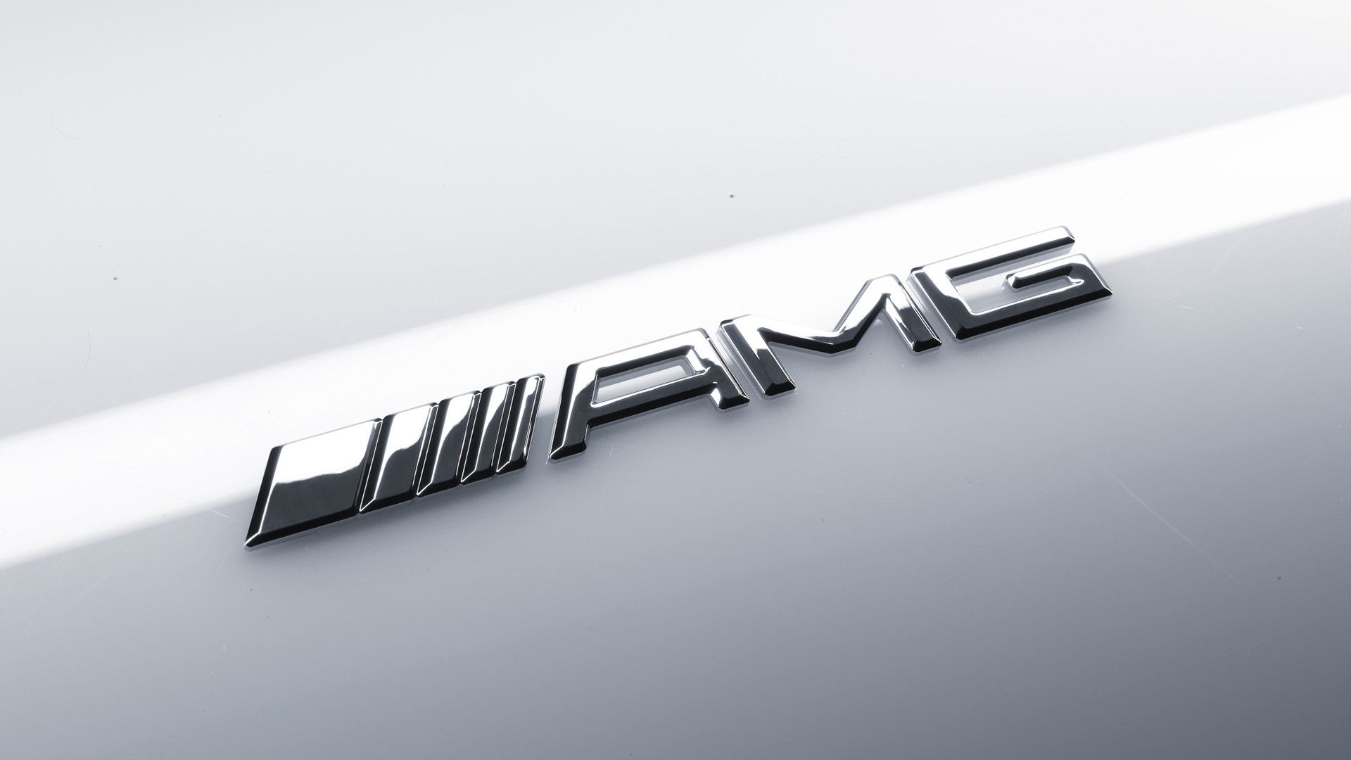 The current AMG logo in metal on white car paint