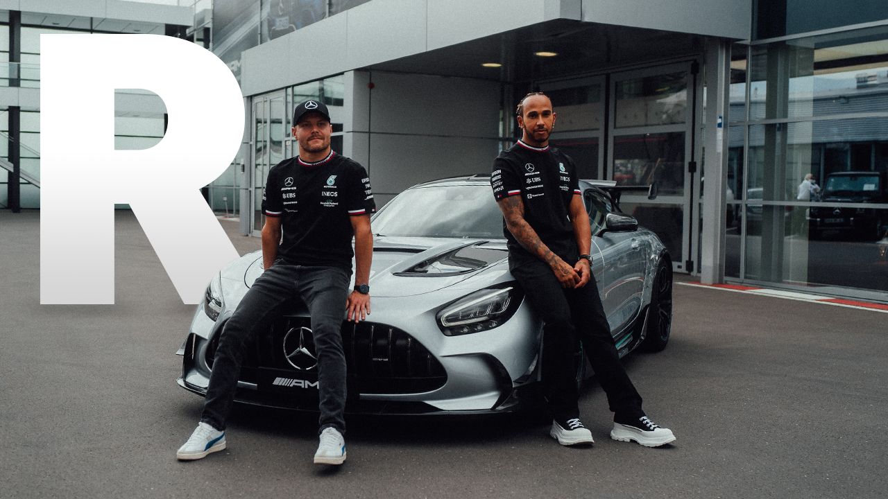 Valtteri Bottas and Lewis Hamilton in front of a Mercedes-AMG Track Series