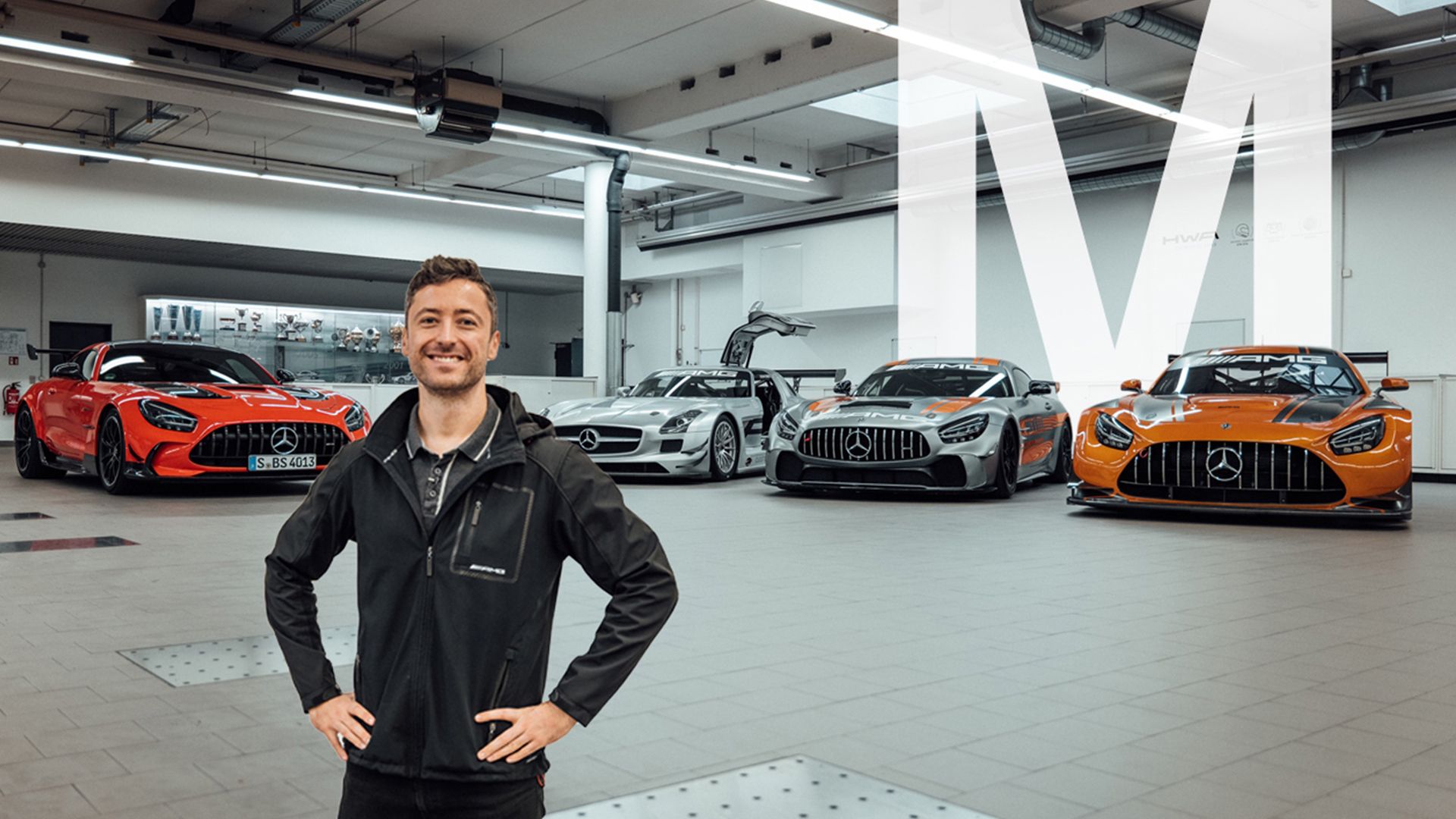 Felix in front of various Mercedes-AMG GT models