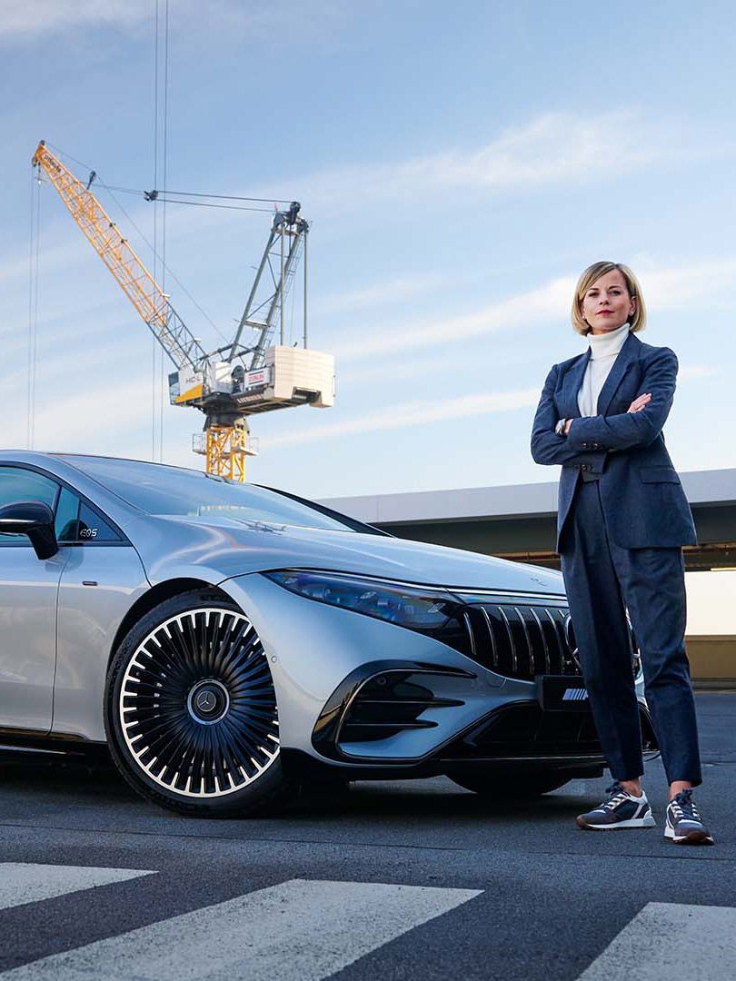 Susie Wolff in front of the Mercedes-AMG EQS 53 4MATIC+