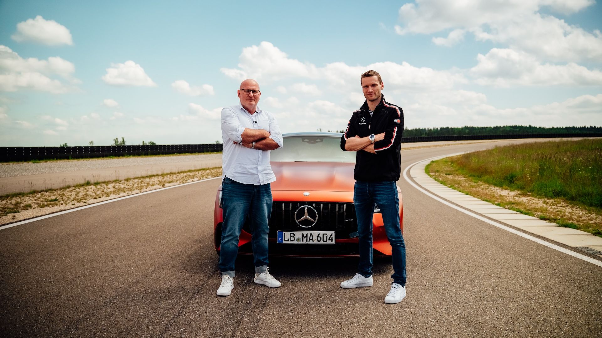 Maro Engel and Jörg Letzel in front of the Mercedes-AMG GT 4-Door Coupé