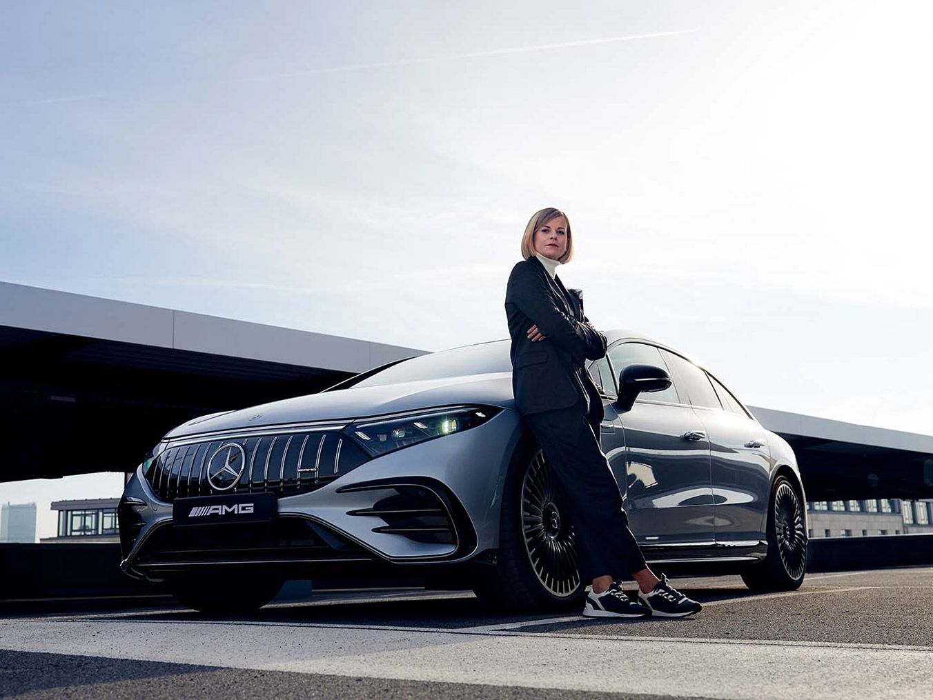 Susie Wolff in front of the Mercedes-AMG EQS 53 4MATIC+ 