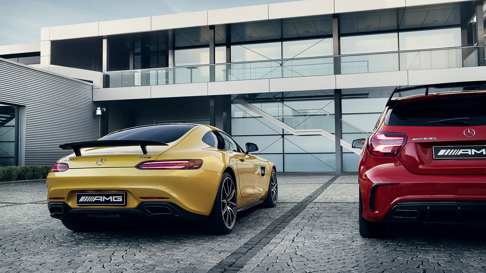 Family ties symbolized by two different AMG vehicles in front of a building