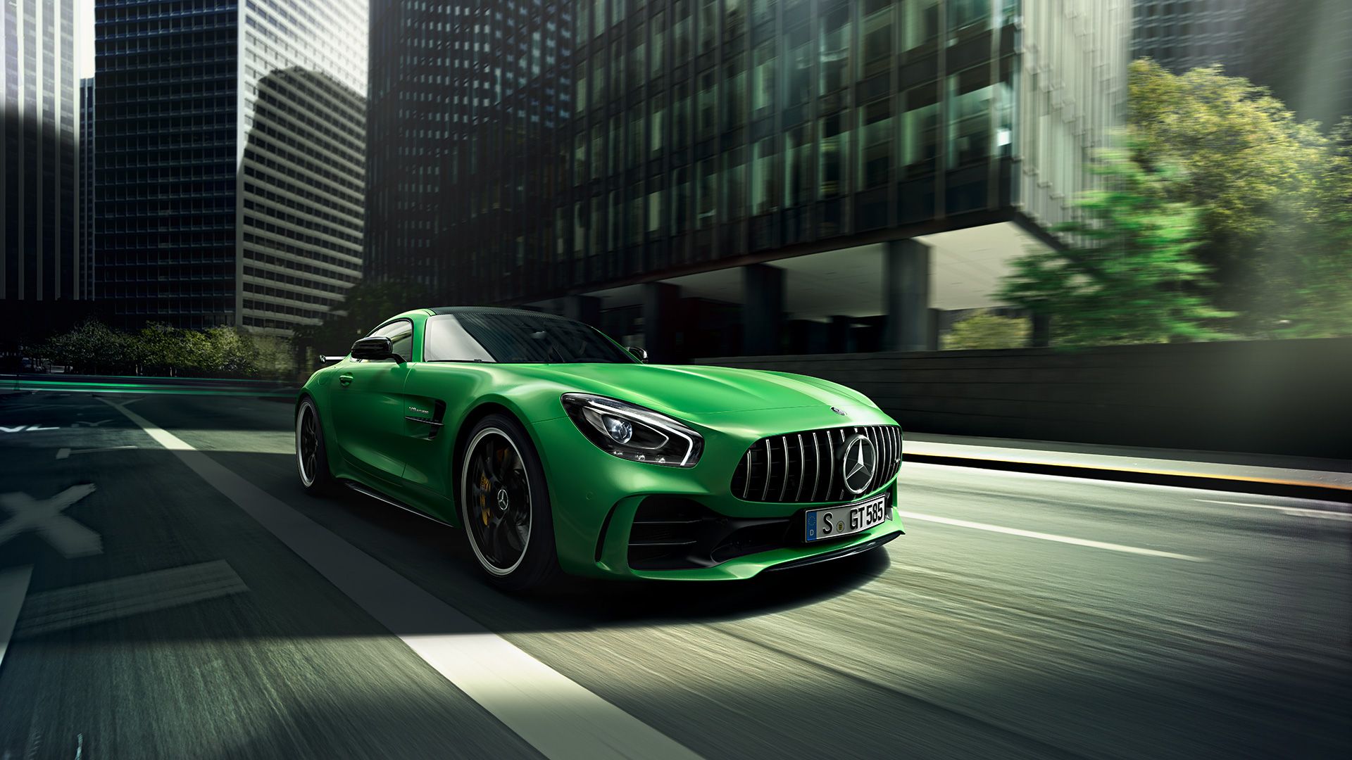 A green AMG vehicle racing through a city