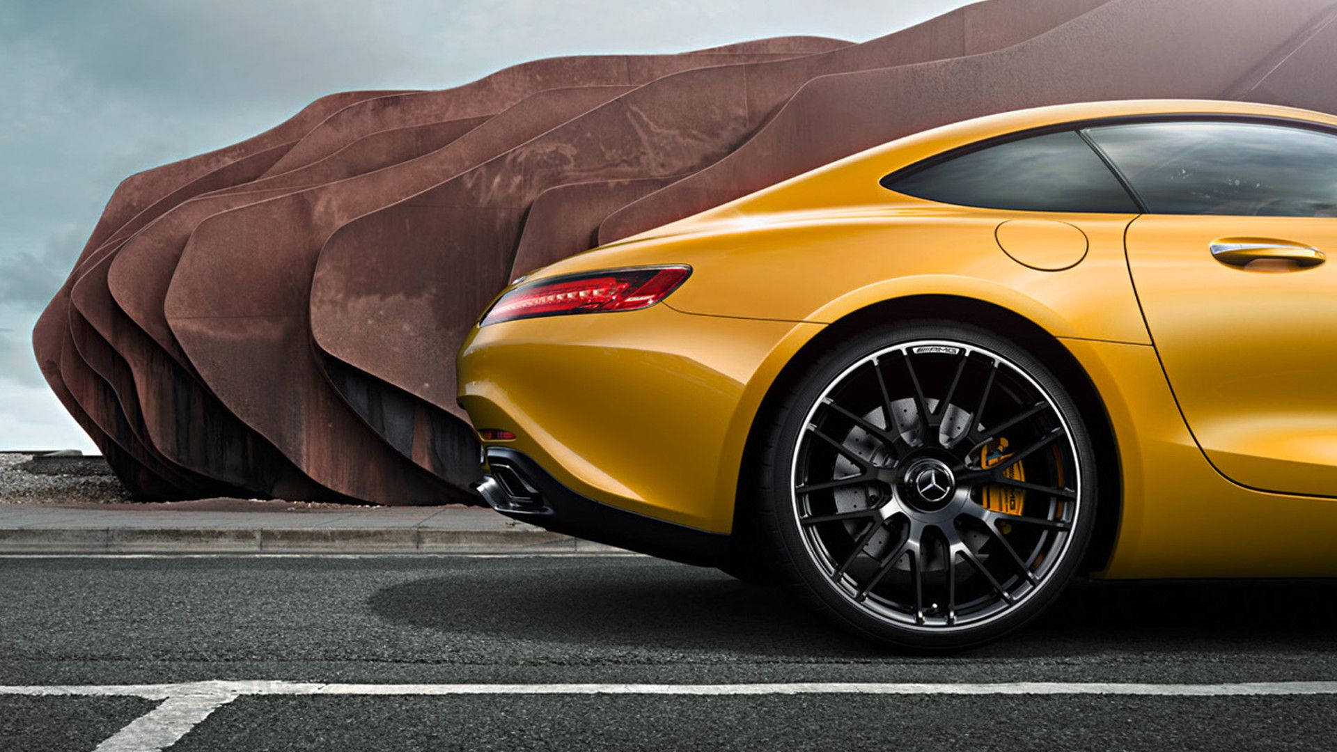 Rear of a yellow Mercedes-AMG in side view