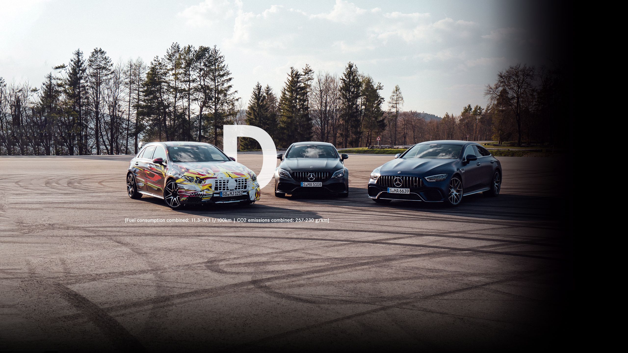 Various Mercedes-AMG models on a test track at the edge of the forest