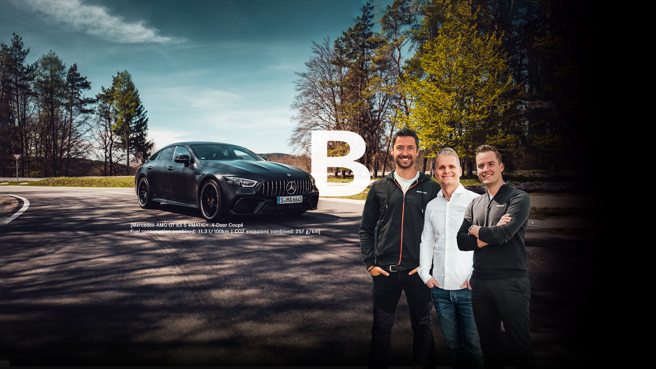 Three AMG engineers in front of a Mercedes-AMG GT 63 4MATIC+ in a forest area