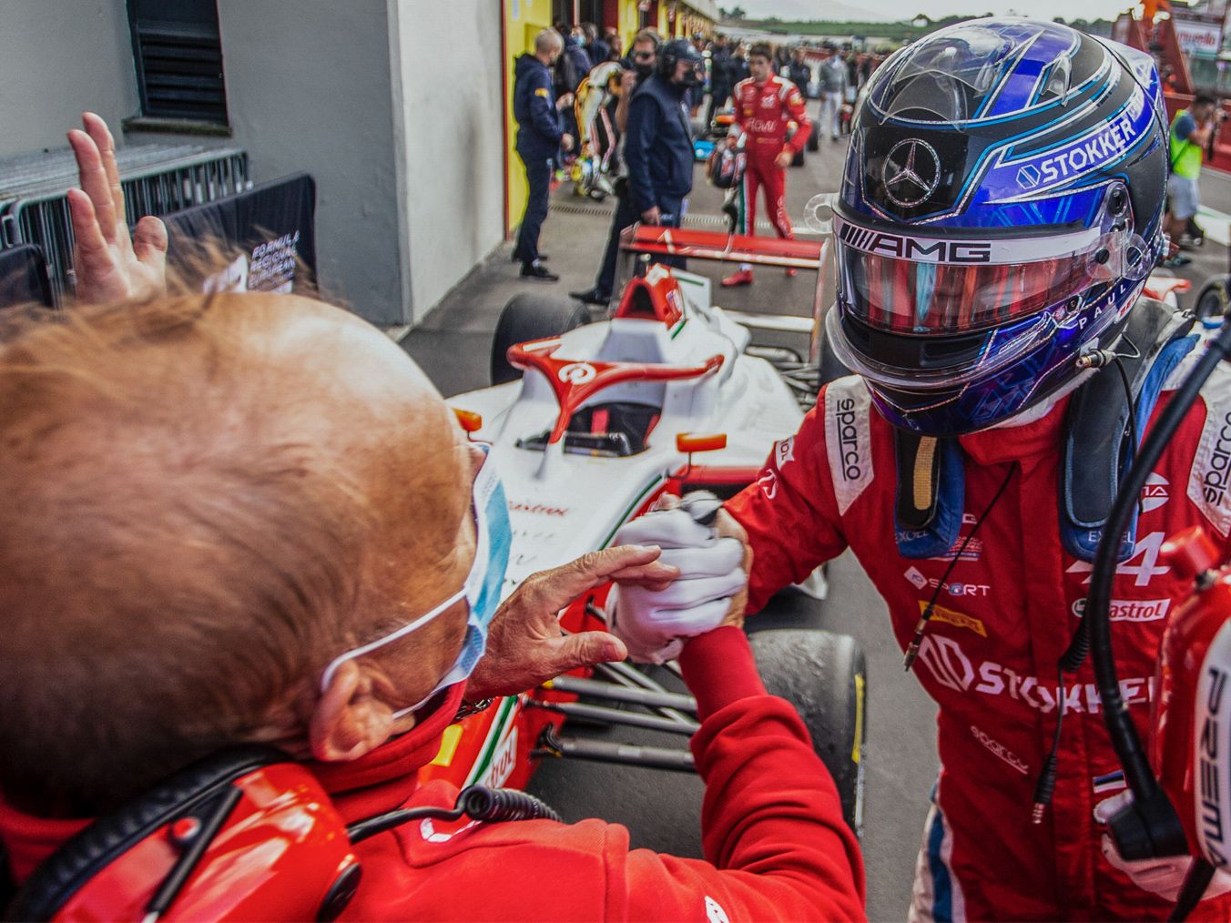 A crewmember and a driver shake hands