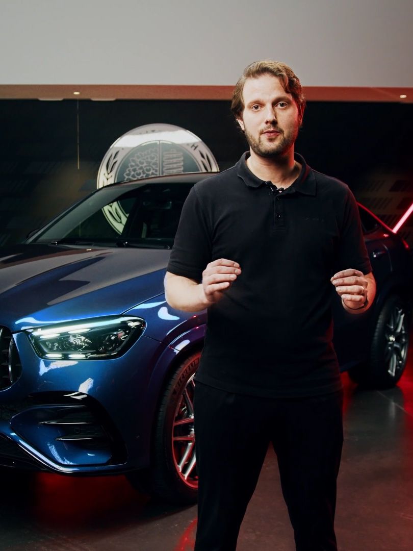 Product manager standing in a show room in front of the new Mercedes-AMG GLE 53 Coupé