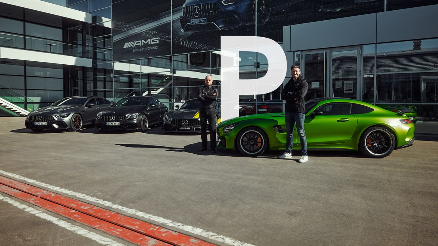 Felix and Frank in front of several Mercedes-AMG vehicles in Affalterbach